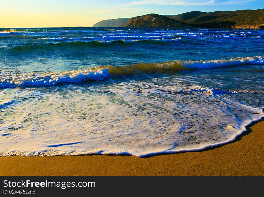 Sand on the Aegean coast and the mountains far away