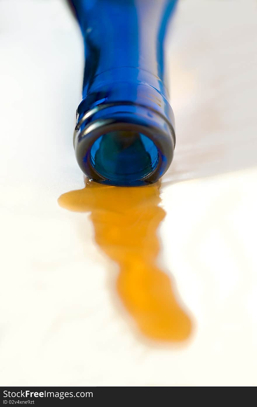 Part of a wine bottle from dark blue glass on a white background. Part of a wine bottle from dark blue glass on a white background