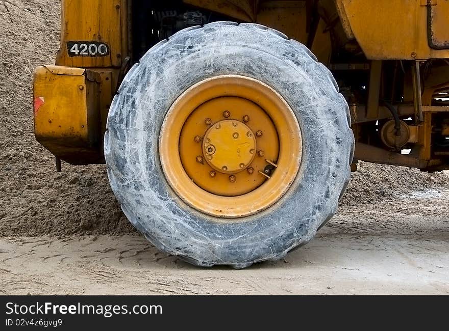 Wheel Of Backhoe Or Tractor Over Sand