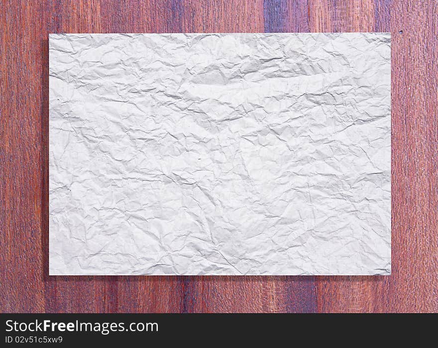 White crumpled paper on wood texture