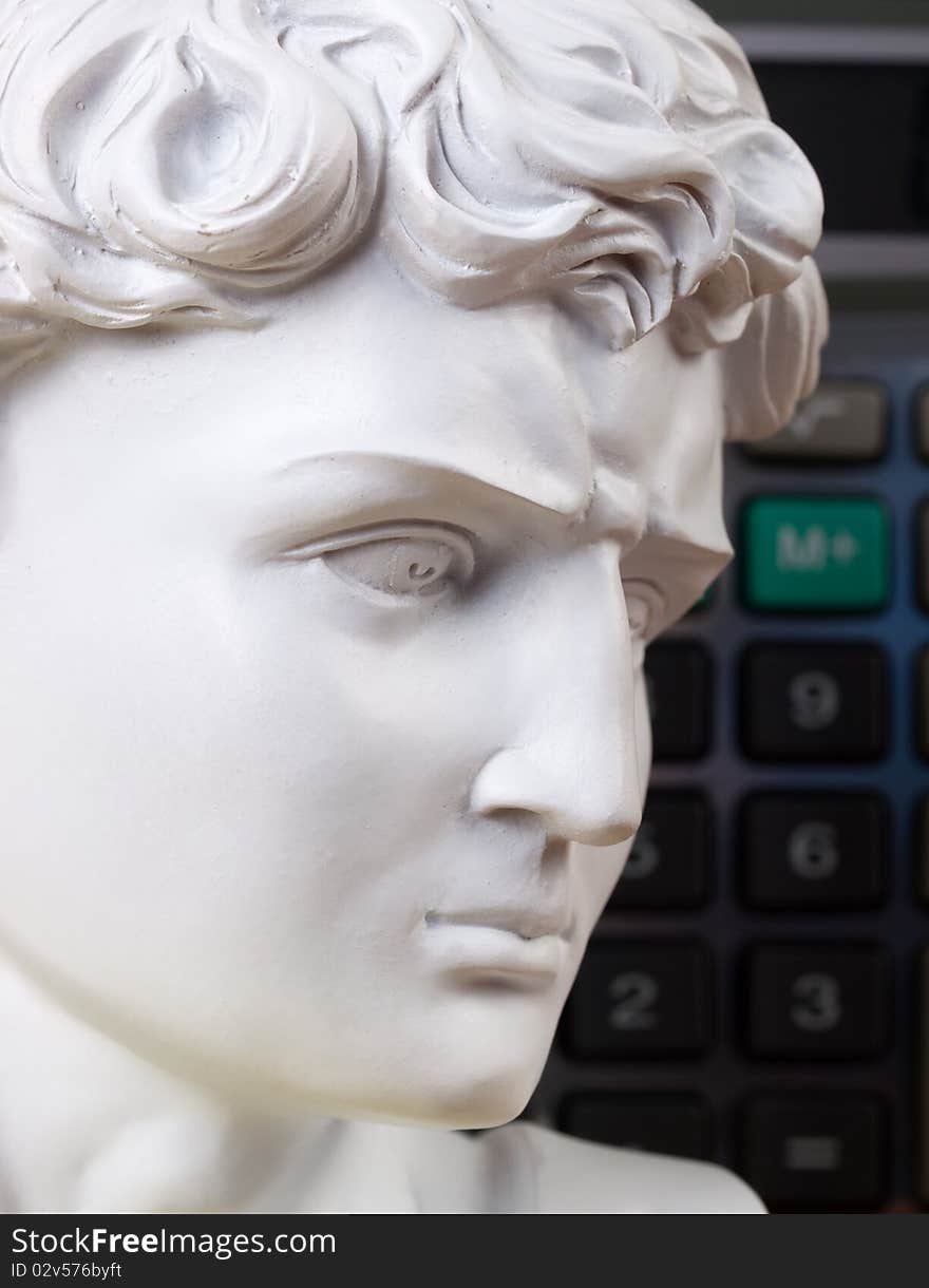 Ancient Roman bust with calculator keys in the background. Ancient Roman bust with calculator keys in the background