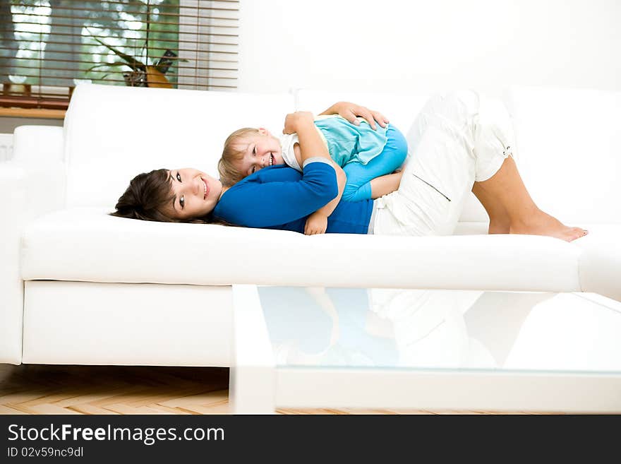 Young mother and her daughter playing at home. Young mother and her daughter playing at home