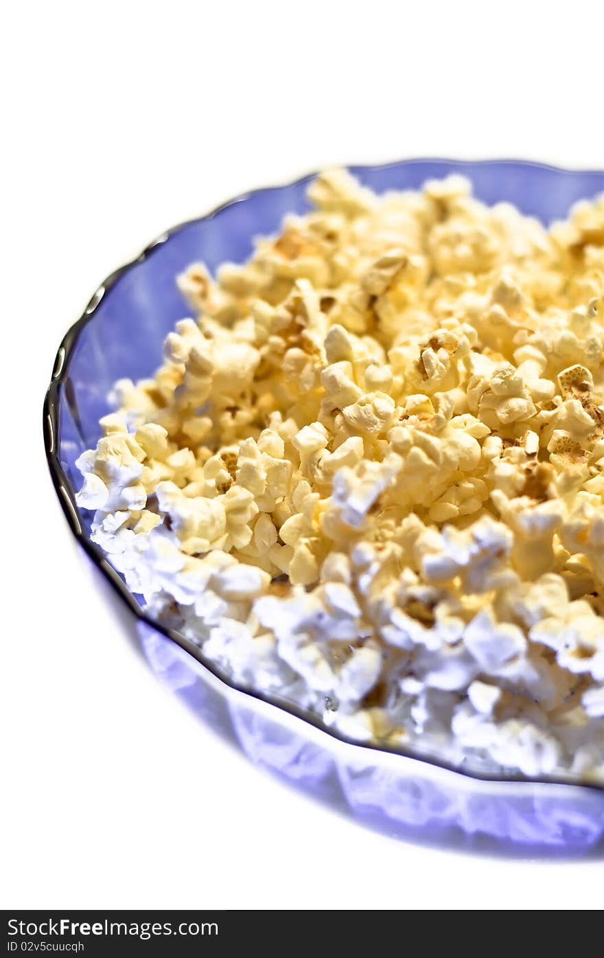 Popcorn in a blue basket. Isolated on a white background.