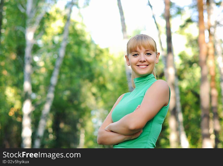 Young beautiful girl in a summer forest