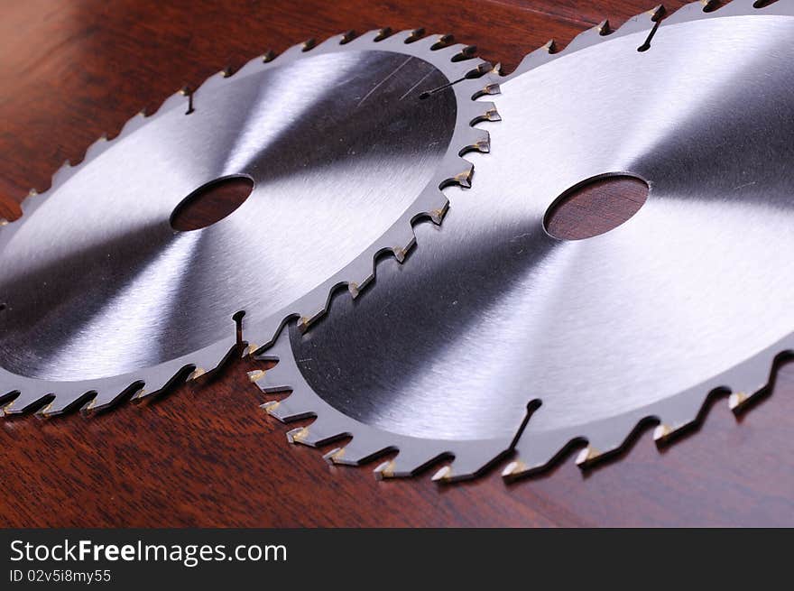 The metal disc is a circular saw on a dark background