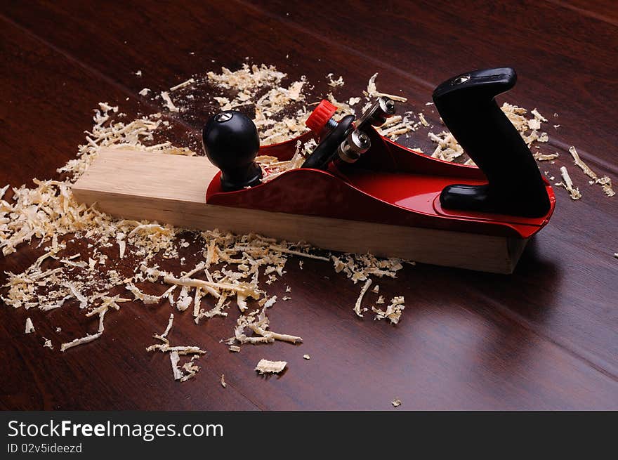 Shavings of wood, brick and red plane