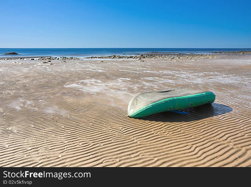 Inverted inflatable boat on the sea tide.