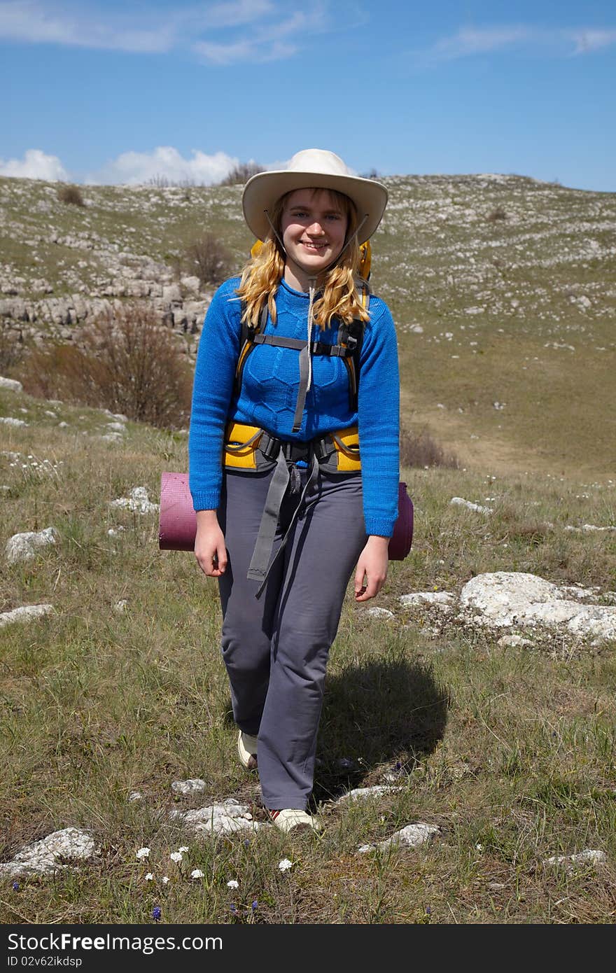 Smiling backpacker girl walking outdoor