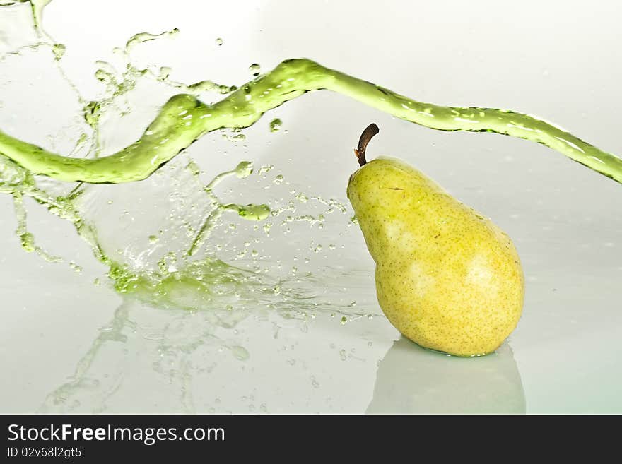 A pear with a splash of water