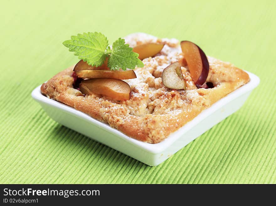 Small plum cake in a square dish