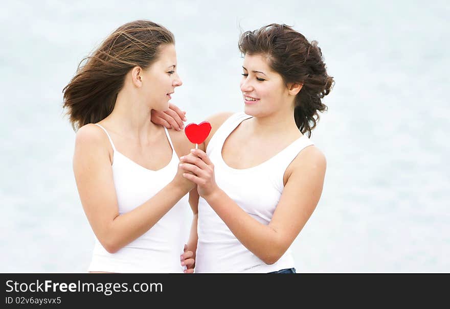 Girls With Heart-shaped Candy On Nature