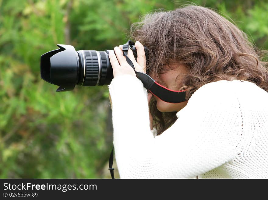 Girl taking picture on natural background. Girl taking picture on natural background