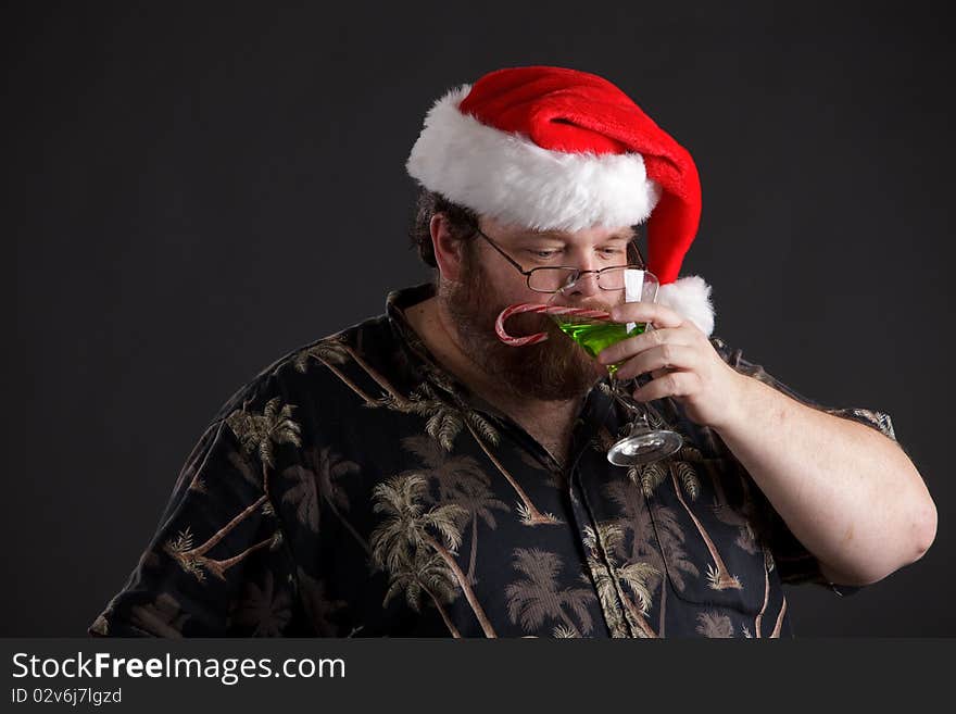 An obese man in Santa hat and tropical shirt