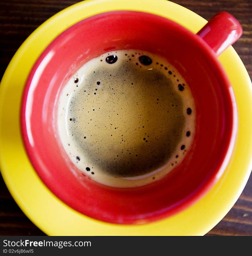 Coffee in red cup and yellow plate