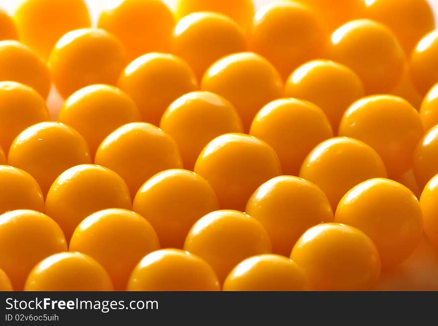 Yellow vitamin pills on a plate