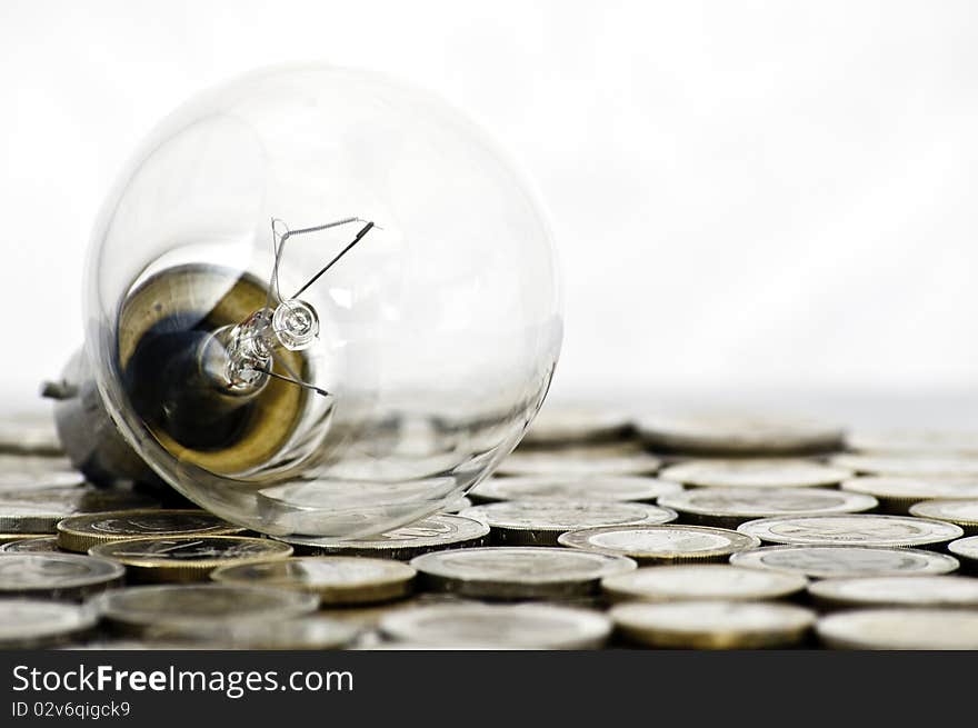 Filament bulb lying on coins