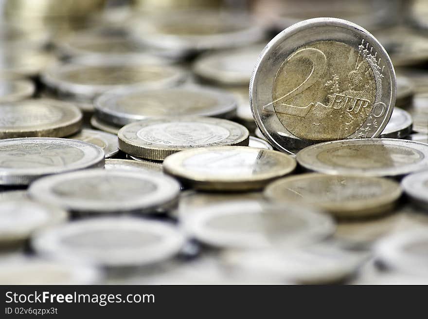 Grungy 2 euro coin with coins on background