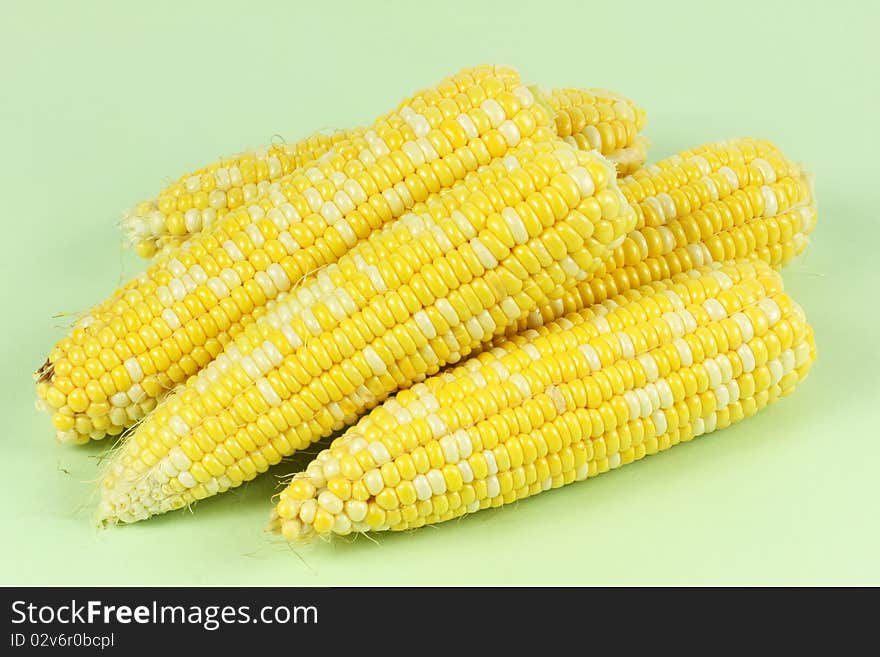 Colorful traditional Thanksgiving corn, isolated on green