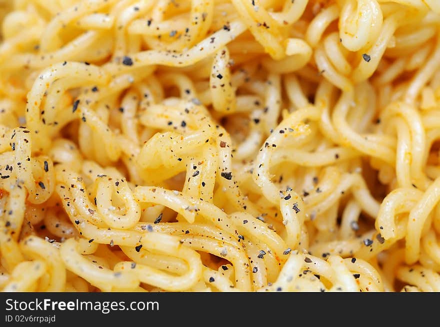 Macro shot of dried noodles with herbal toppings. Suitable for concepts such as diet and nutrition, textures and backgrounds, and food and beverage. Macro shot of dried noodles with herbal toppings. Suitable for concepts such as diet and nutrition, textures and backgrounds, and food and beverage.