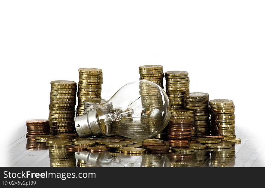 Filament bulb lying on euro coins. Filament bulb lying on euro coins