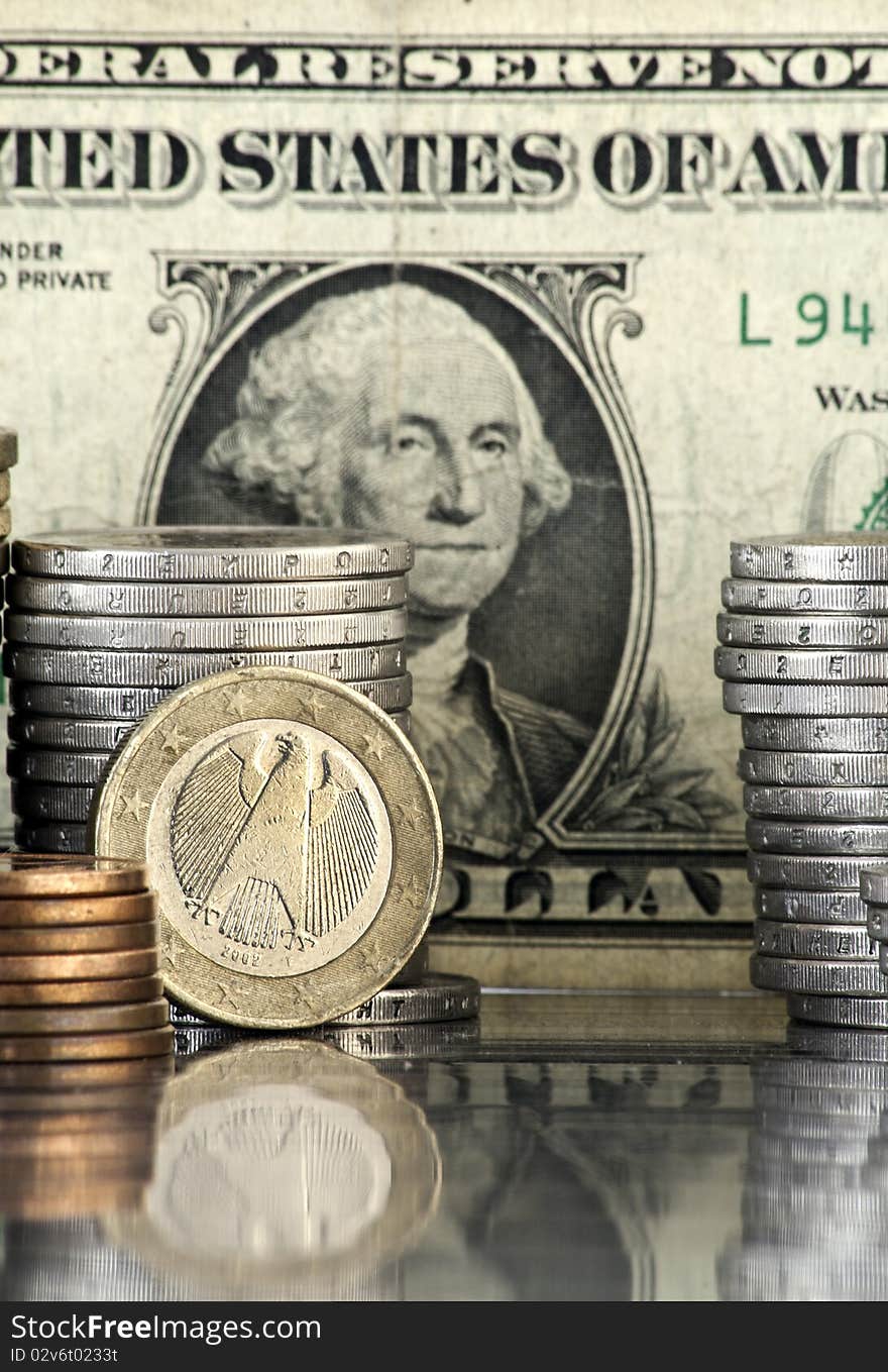 German euro coin with us dollar banknote in background. German euro coin with us dollar banknote in background