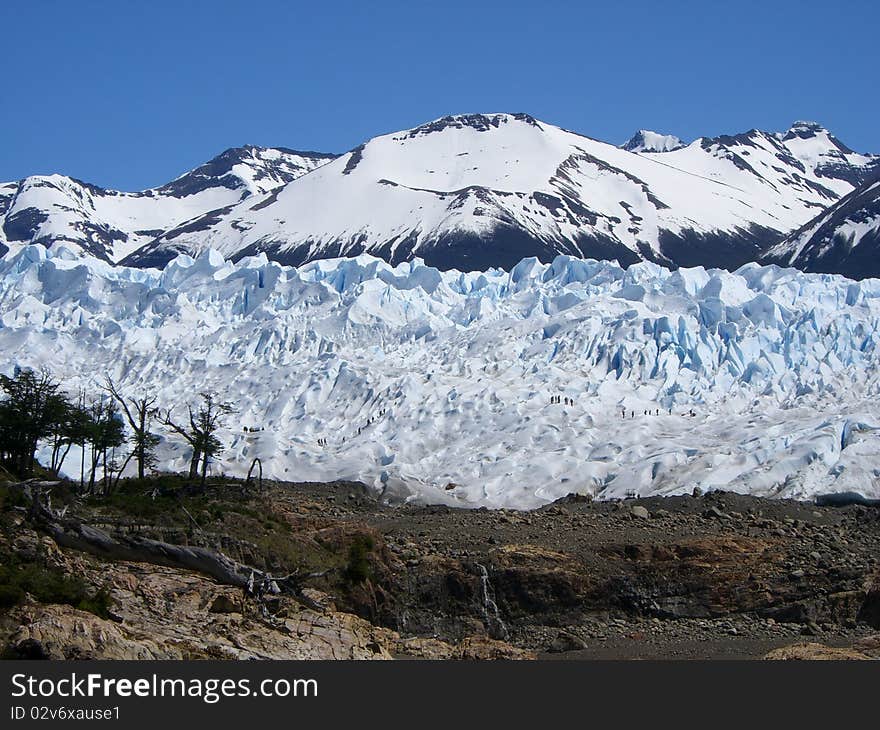 People from a distance walking along glacier. People from a distance walking along glacier