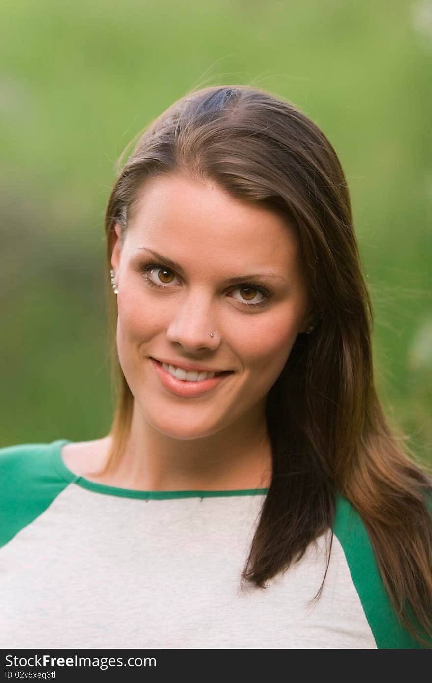 A young model smiling in an outdoor portrait. A young model smiling in an outdoor portrait