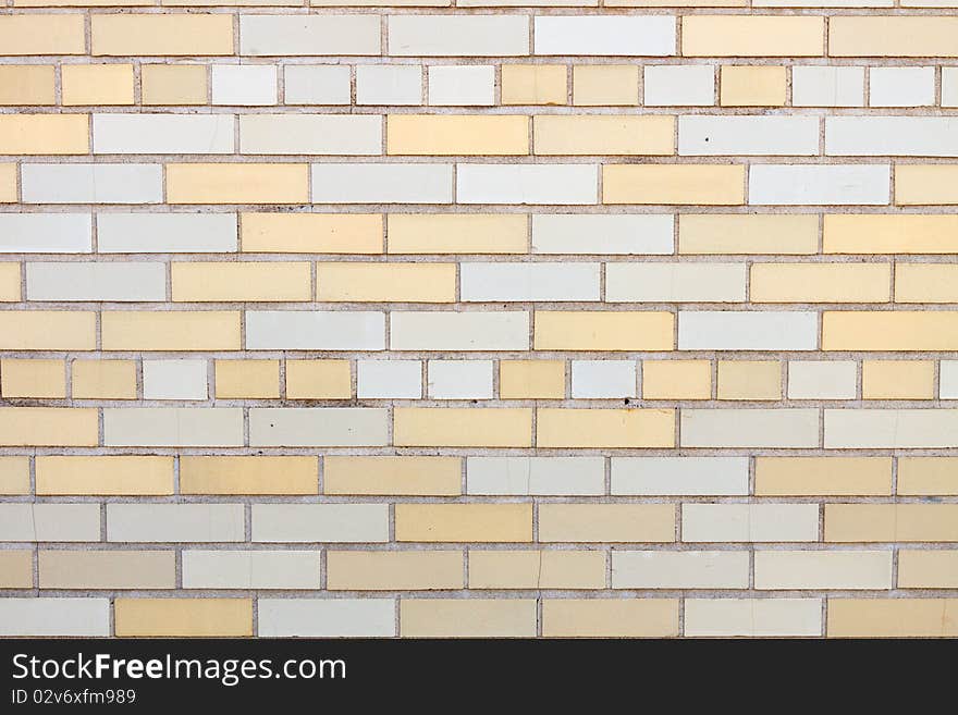 Yellow and white brick wall; in horizontal orientation