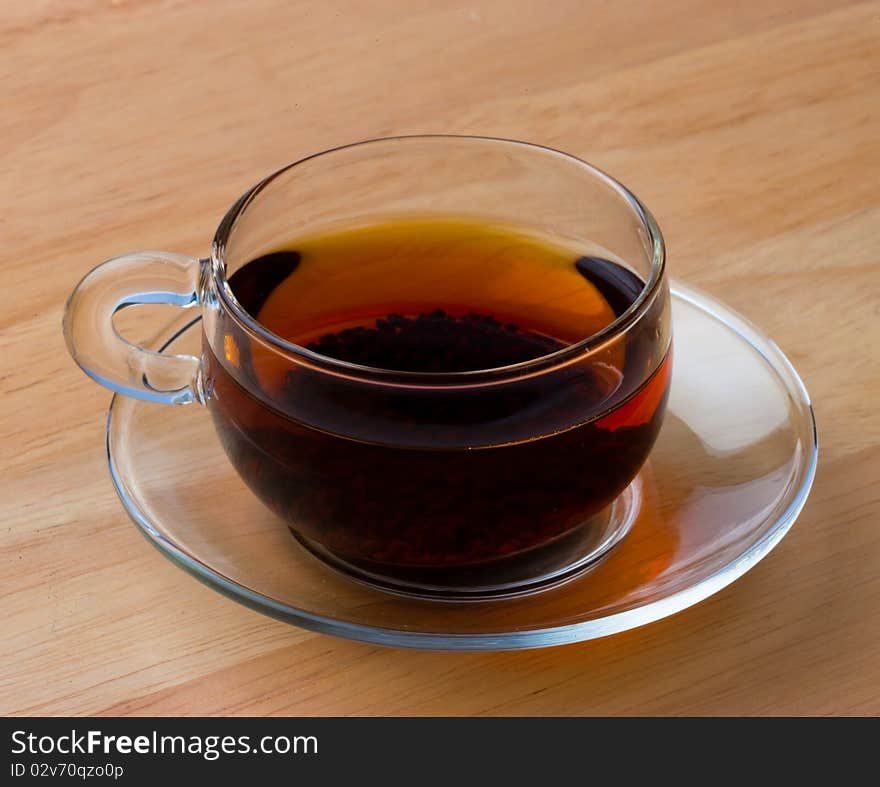 Tea in a Class Cup sat on a wooden table