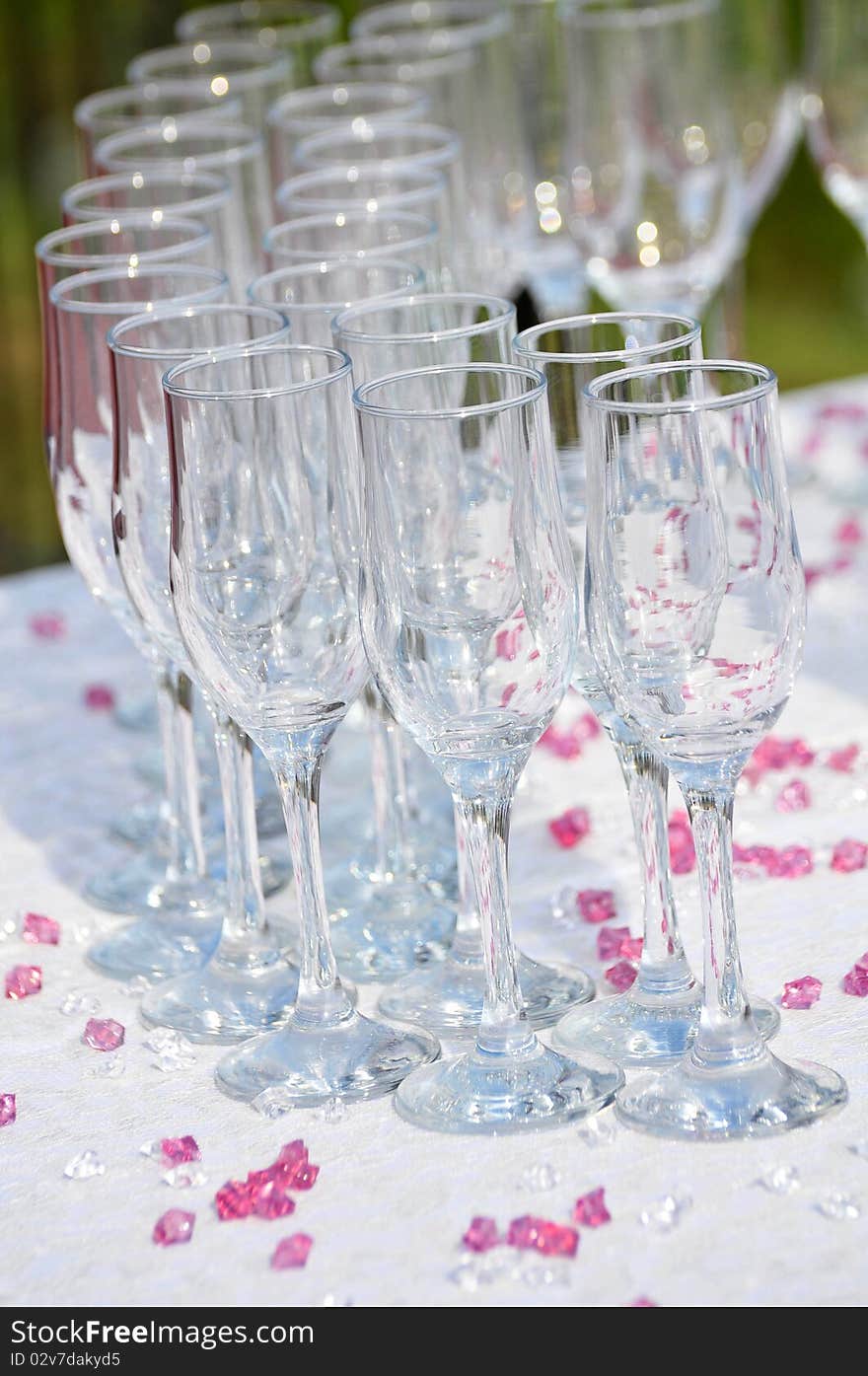 Arrangement with glasses and purple stones on a wedding. Arrangement with glasses and purple stones on a wedding