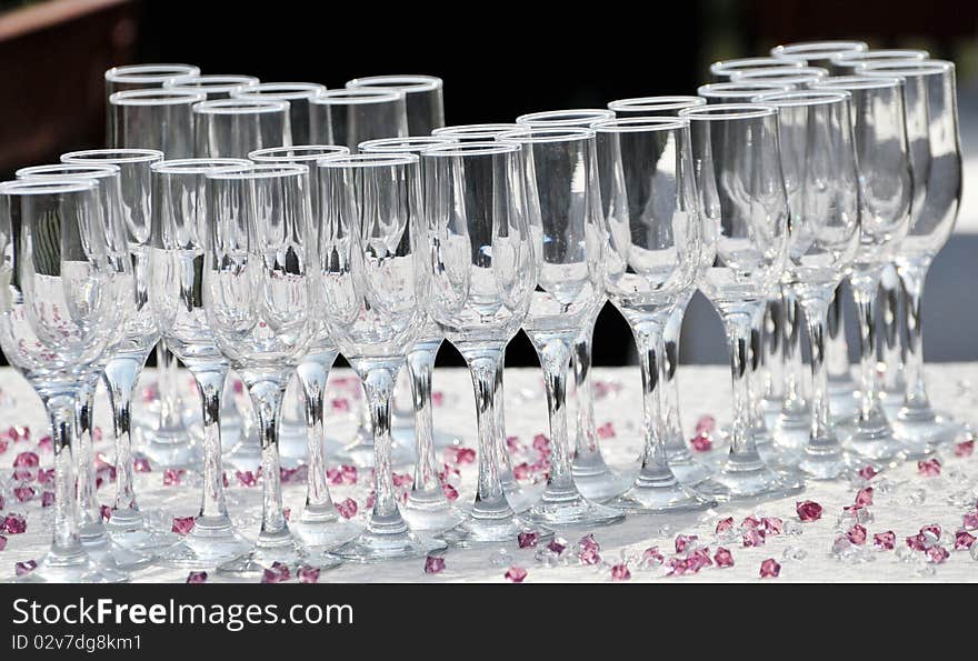 Arrangement with glasses and purple stones on a wedding. Arrangement with glasses and purple stones on a wedding