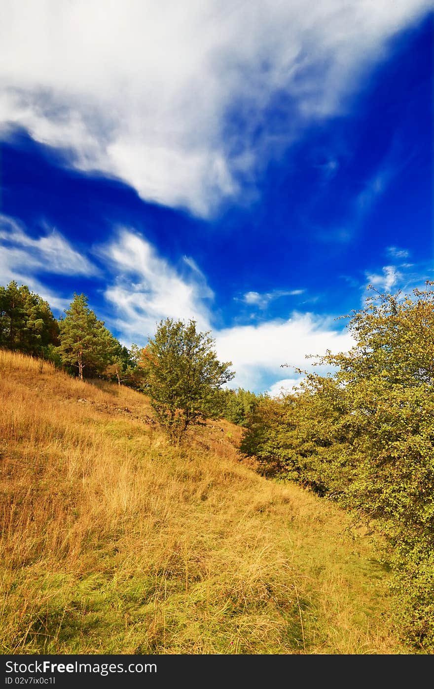 Nice autumnal hill and wonderful blue sky with clouds. Nice autumnal hill and wonderful blue sky with clouds.