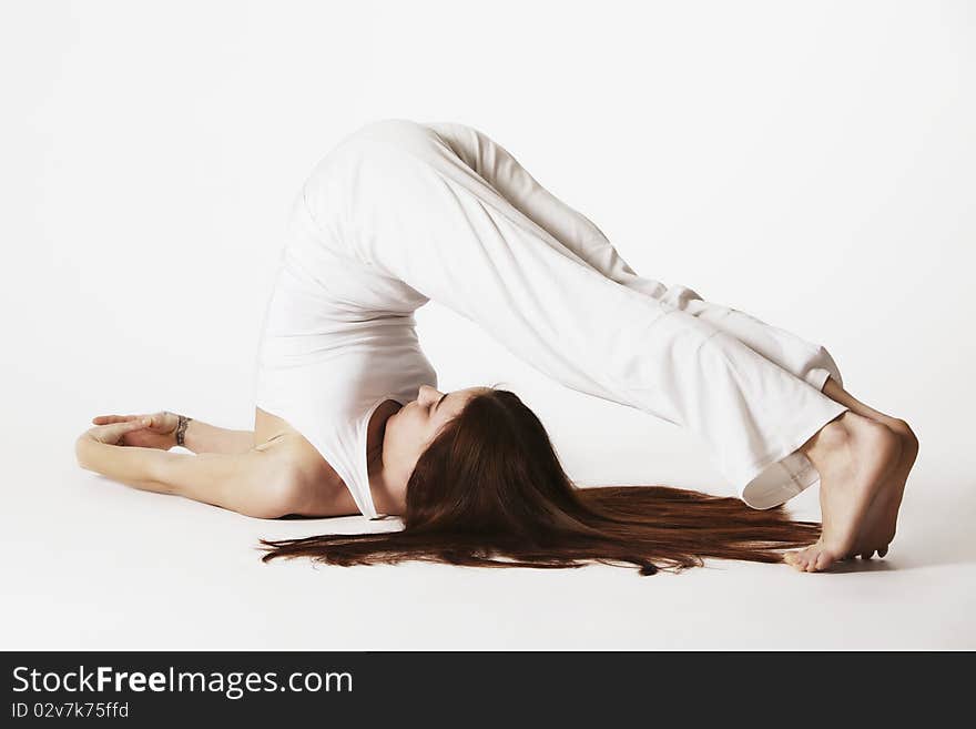 Woman In Plough Yoga Posture (Halasana)