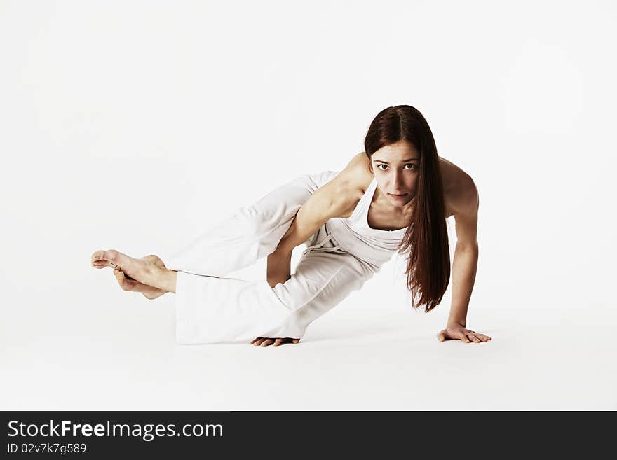 Woman in sideways crow pose (Ashtavakrasana)