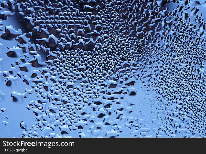 Closeup of crystal clear water drops lying on dark mirror background. Closeup of crystal clear water drops lying on dark mirror background