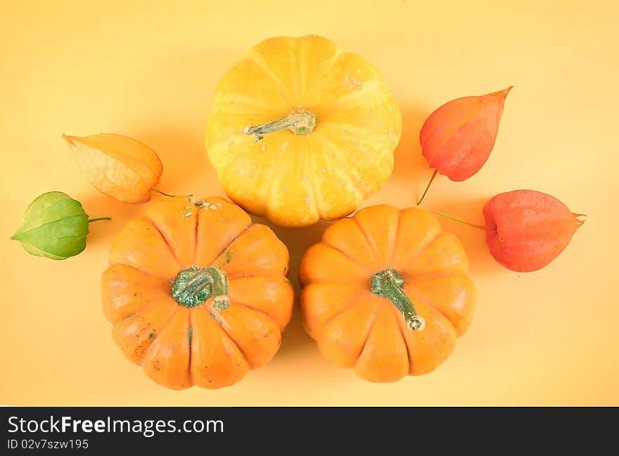 Orange pumpkins on yellow background. Orange pumpkins on yellow background