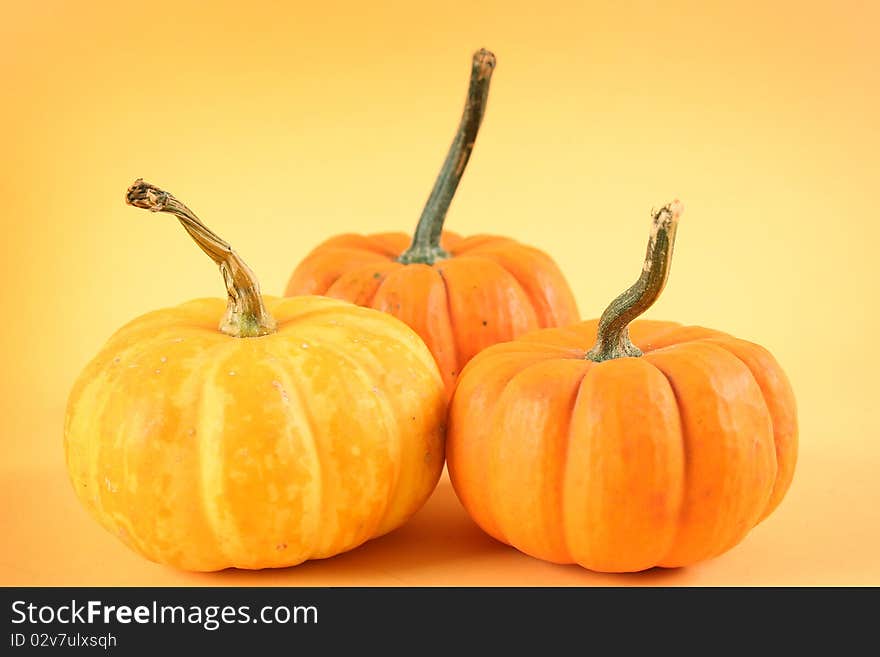 Orange pumpkin on yellow background. Orange pumpkin on yellow background