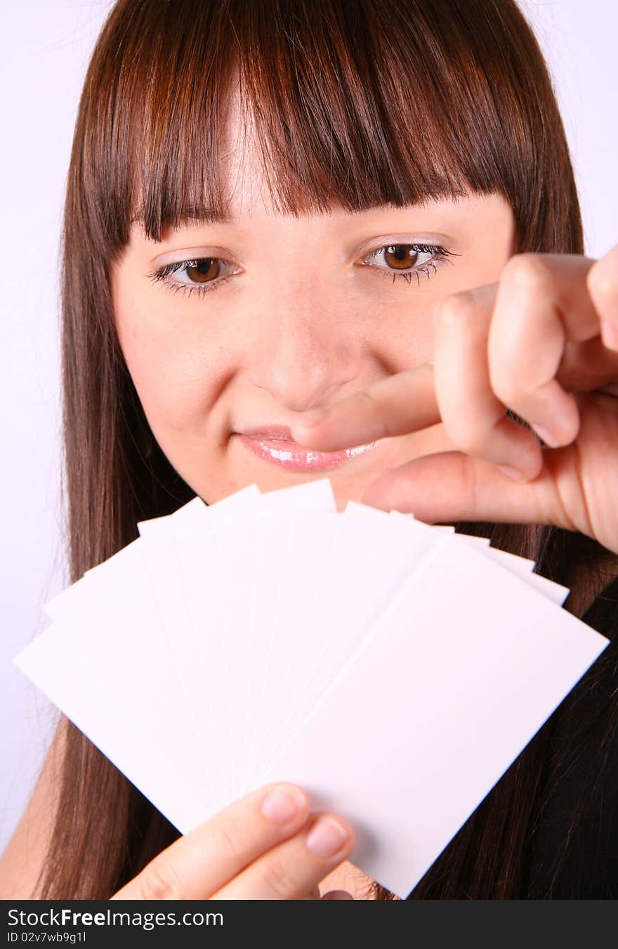 Young woman holding a fan of blank business cards in her hand and choosing one of them. Young woman holding a fan of blank business cards in her hand and choosing one of them