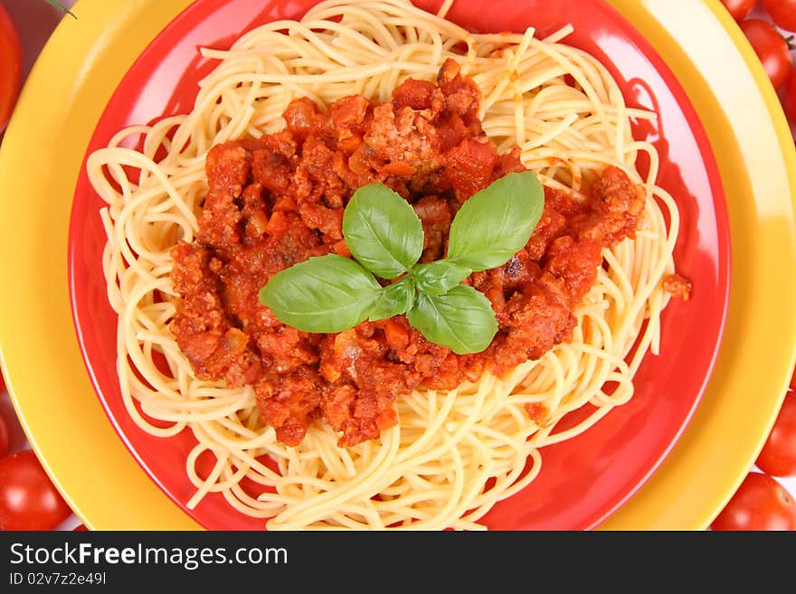 Spaghetti Bolognese on a plate decorated with fresh basil in close up