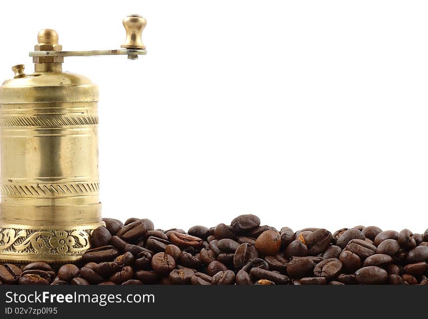 Crusher of coffee with coffee grains on a white background close up. Crusher of coffee with coffee grains on a white background close up