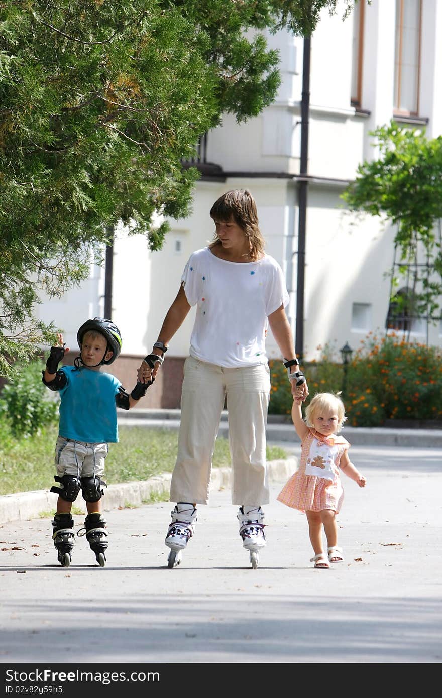 Mother with two children rollerskaing