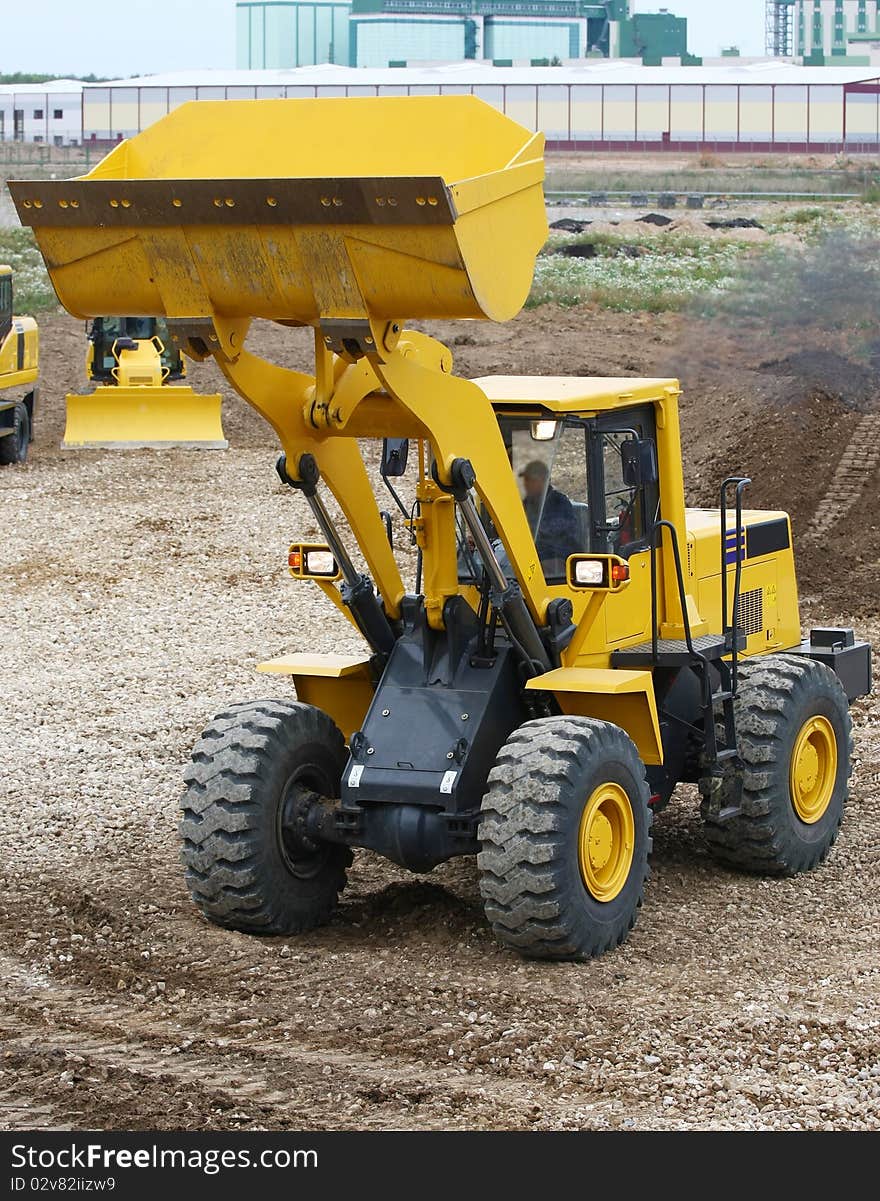 The image of bulldozer works at the ground