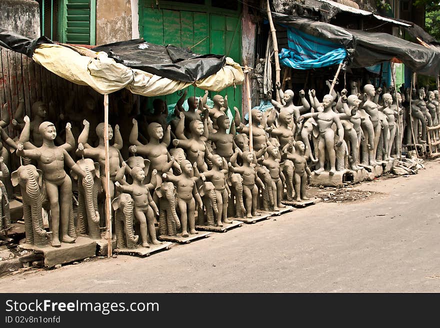 Numerous clay idols for sale on the eve of Viswakarma puja festival in a street in Kolkata, India