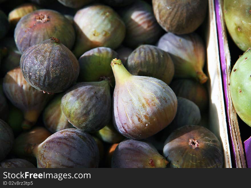 Fresh ripe figs in crate on market