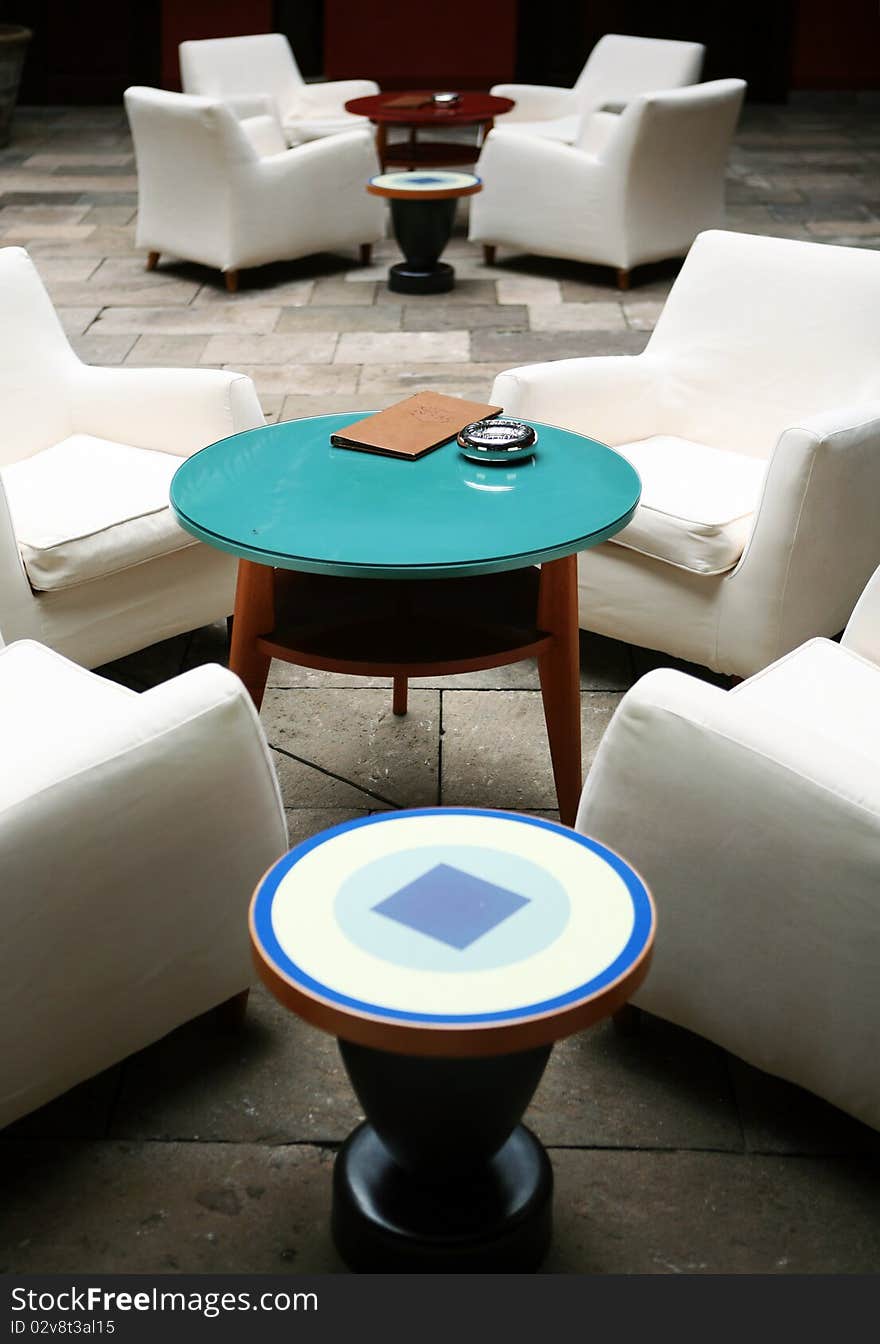 Cafe indoor with white sofas and blue glass small table. Cafe indoor with white sofas and blue glass small table