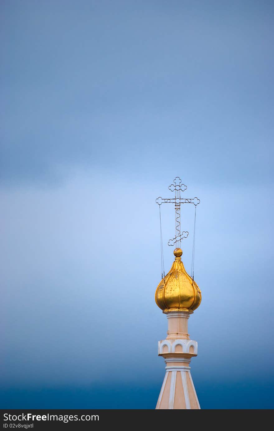 Gold dome of an orthodox temple with a cross