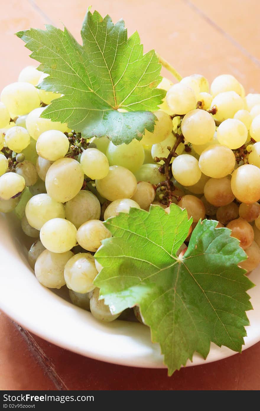 Clusters of green grapes on the plate