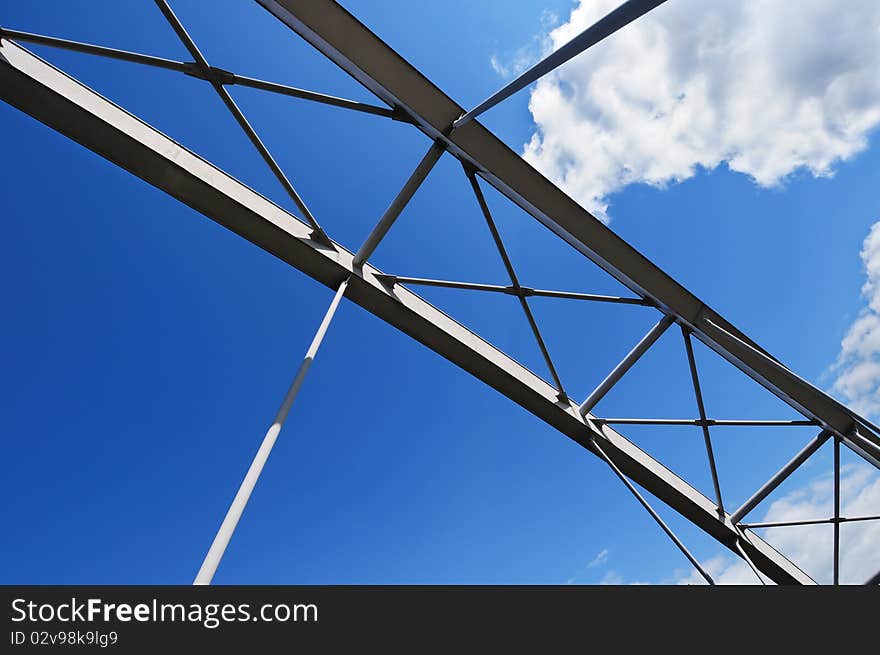 Elements of modern tied arch bridge on picturesque cloudy sky. Elements of modern tied arch bridge on picturesque cloudy sky