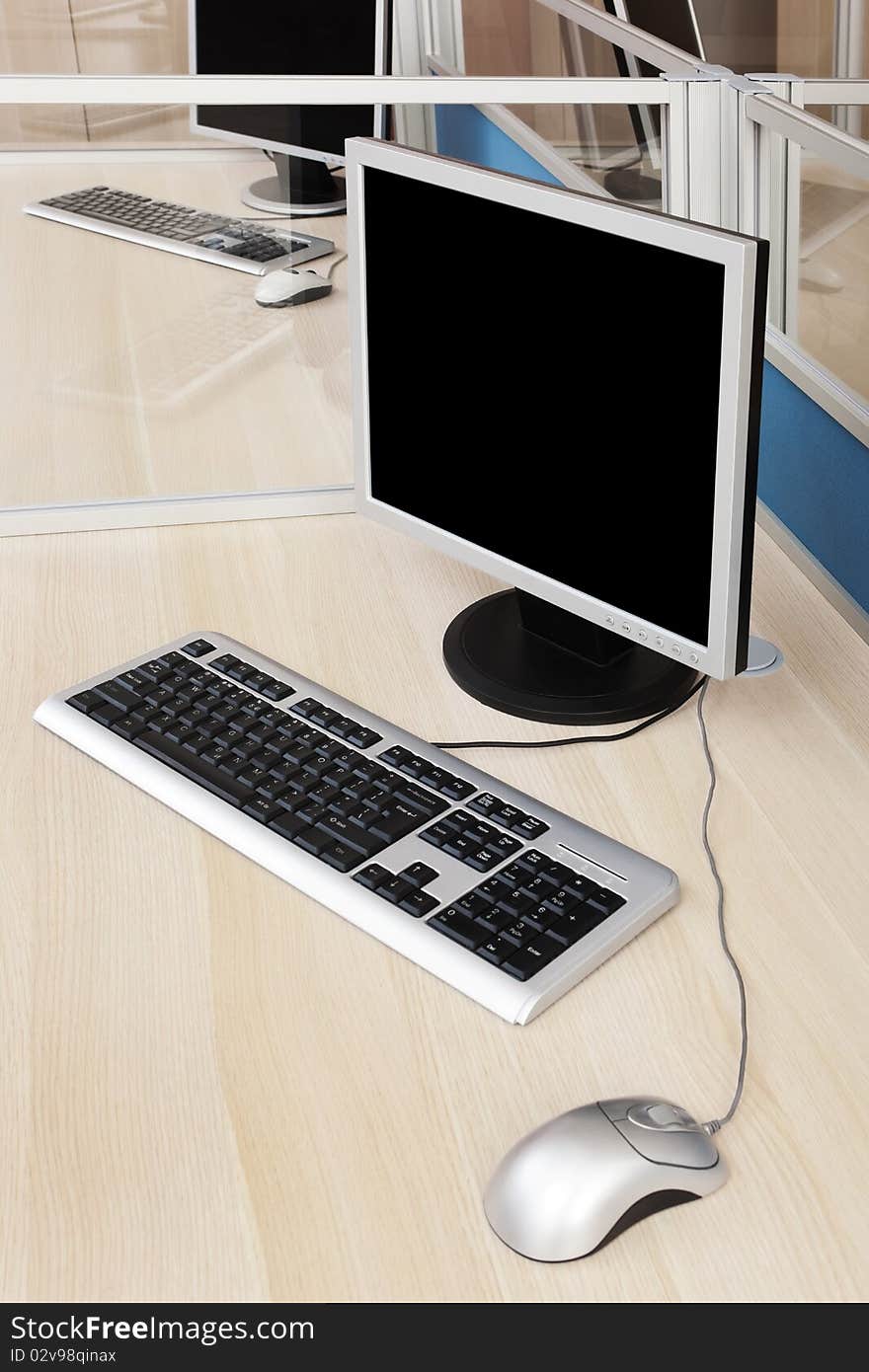 Computers behind the glass in a modern office