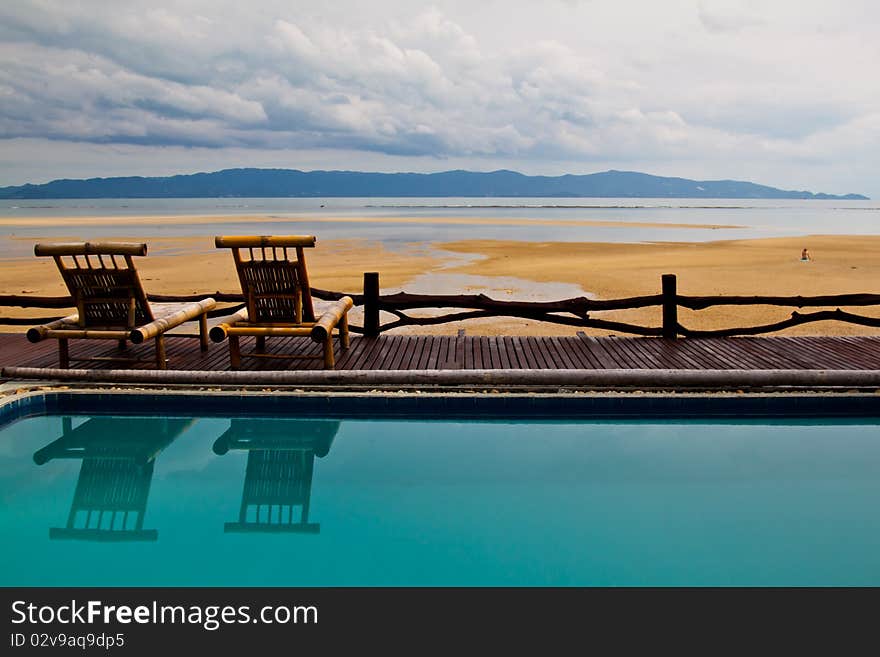 A beachfront resort with a pool and a sun deck overlooking the Koh Samui Island in Thailand. A beachfront resort with a pool and a sun deck overlooking the Koh Samui Island in Thailand